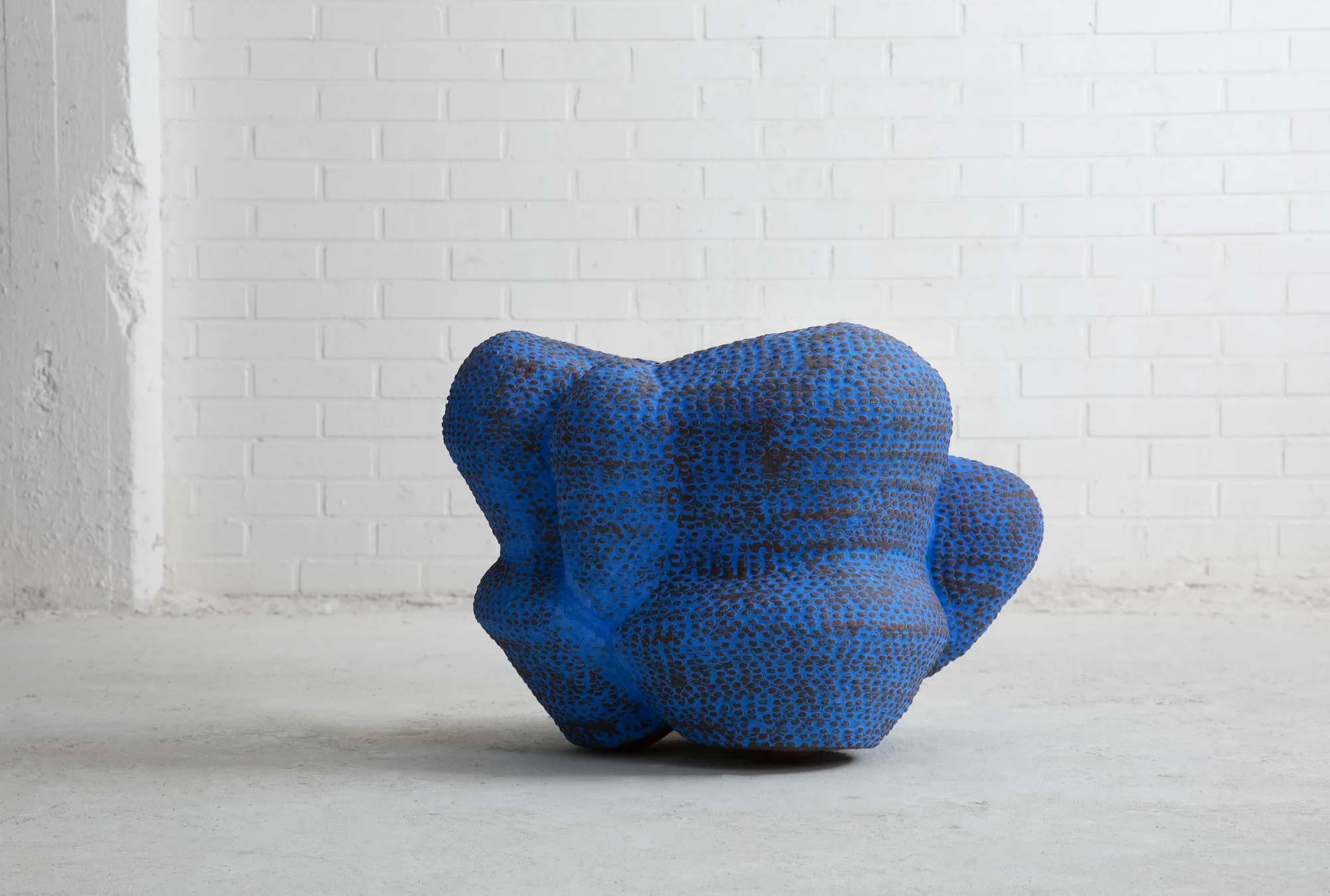 Hand-built ceramic vessel in a gallery space